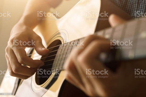 Person Playing Guitar