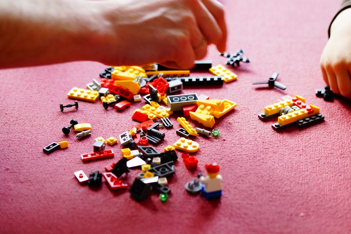 Hand grabbing Legos